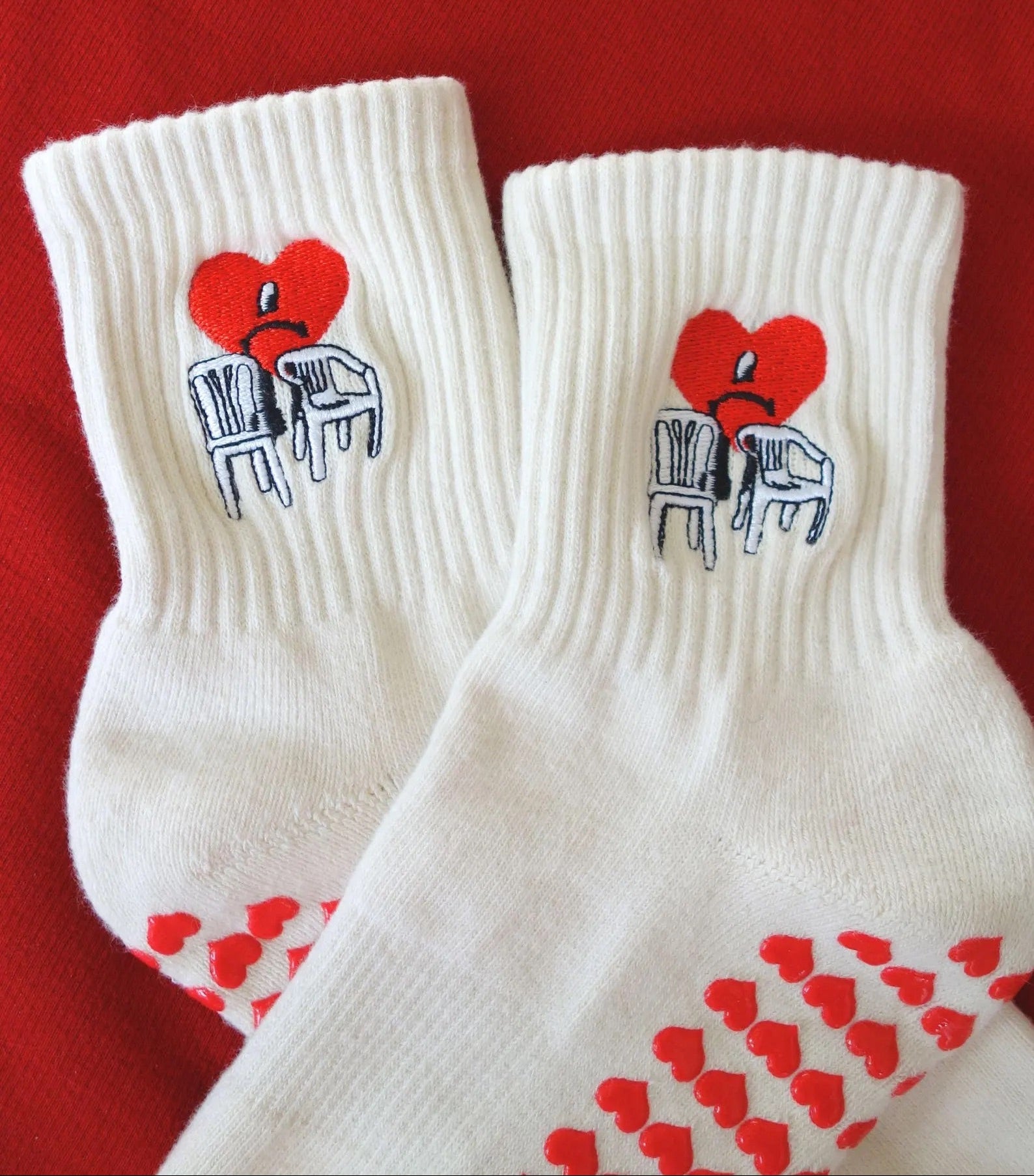 White socks with red hearts and heart with chairs embroidery of bad bunny icons